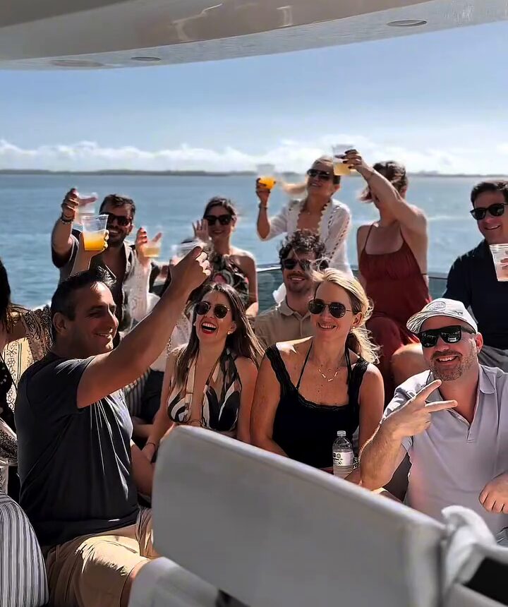 Friends raising drinks on a yacht deck