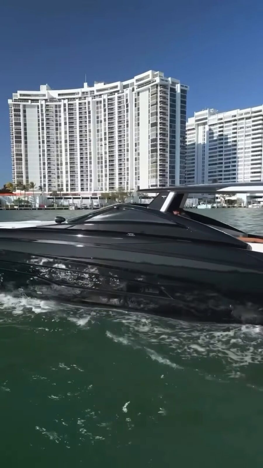 Tecnomar 53 running past high-rises